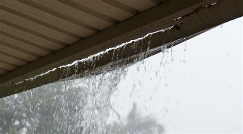 Water dripping and running down from the roof on the street - sound effect