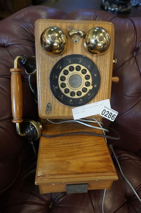 An old rotary telephone from 1927: they pick up the phone and hang up - sound effect