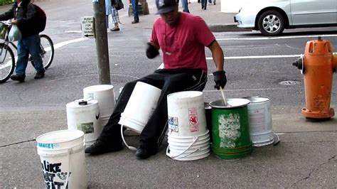 Street musician playing homemade drums, urban atmosphere - sound effect