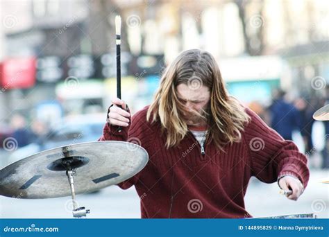 Street musician playing homemade drums, urban atmosphere - sound effect