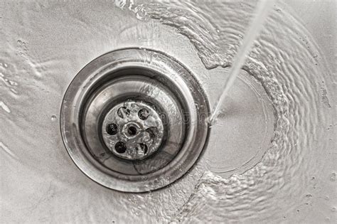 Water flows quickly into a metal sink, the drain is opened - sound effect