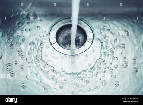 Water flows quickly into a metal sink, the drain is opened - sound effect