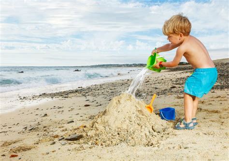 Sound of sand, pouring sand from a plastic bucket on the ground