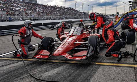 Racing, sounds of a pit stop, the car stops and starts the engine