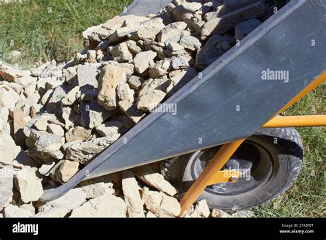 Gravel is poured out of a construction wheelbarrow - sound effect