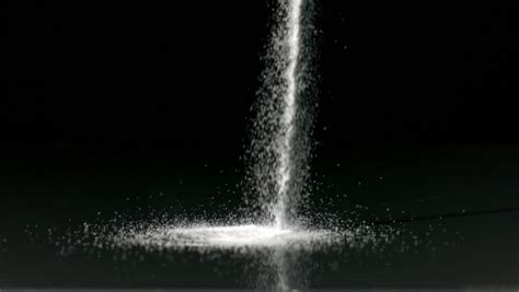 Rock salt is poured onto the ground slowly - sound effect