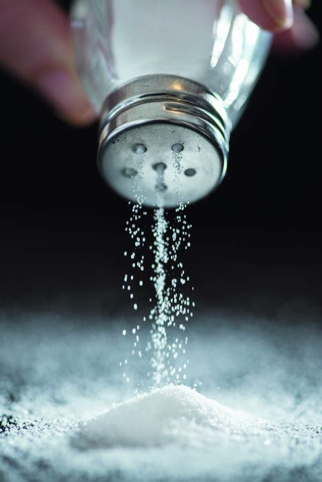 Rock salt is poured into a plastic bucket - sound effect