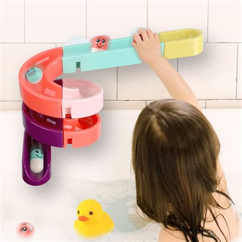 Boy 11 months old bathing in a bathtub with a toy - sound effect