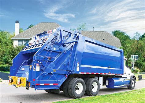 Garbage truck reverses and loads garbage - sound effect