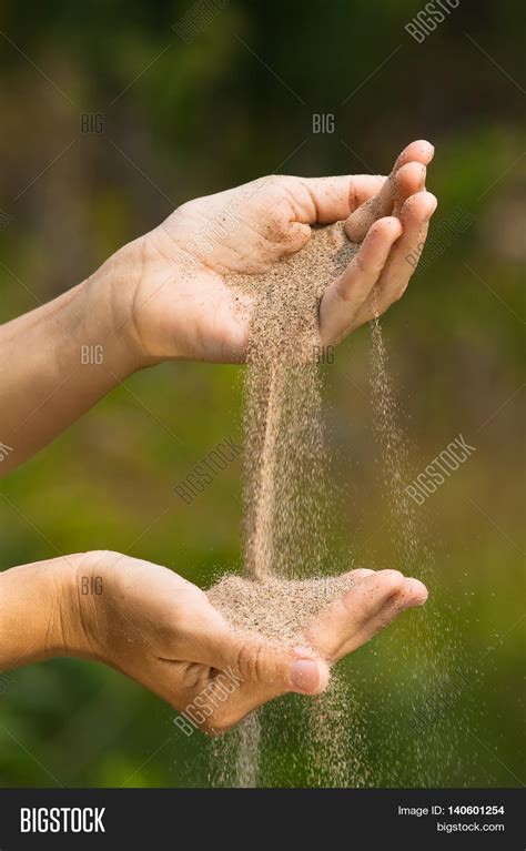 Sand is poured from a wooden container onto the ground - sound effect