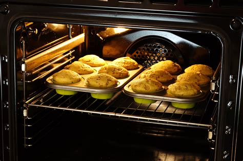 Pan is placed on a baking sheet and taken out of oven.   - sound effect