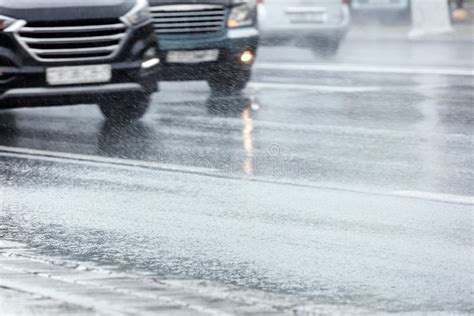 Wet suburban road, moving traffic - sound effect